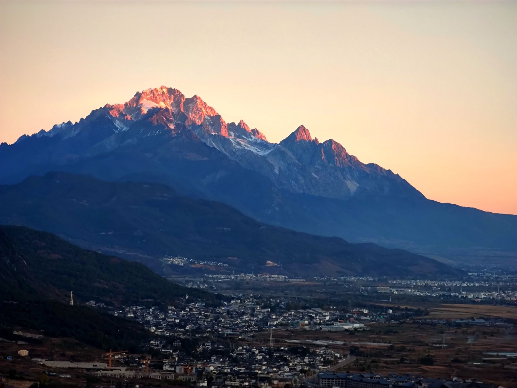 Jade Dragon Snow Mountain lit pink above the town of Lijiang